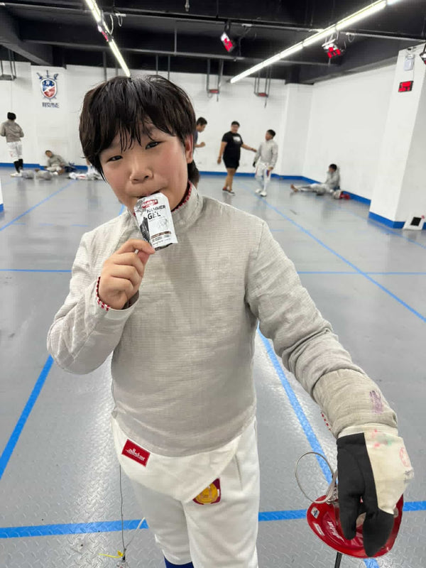 Young sabre fencer Drake Chung with a Hammer Gel at fencing training