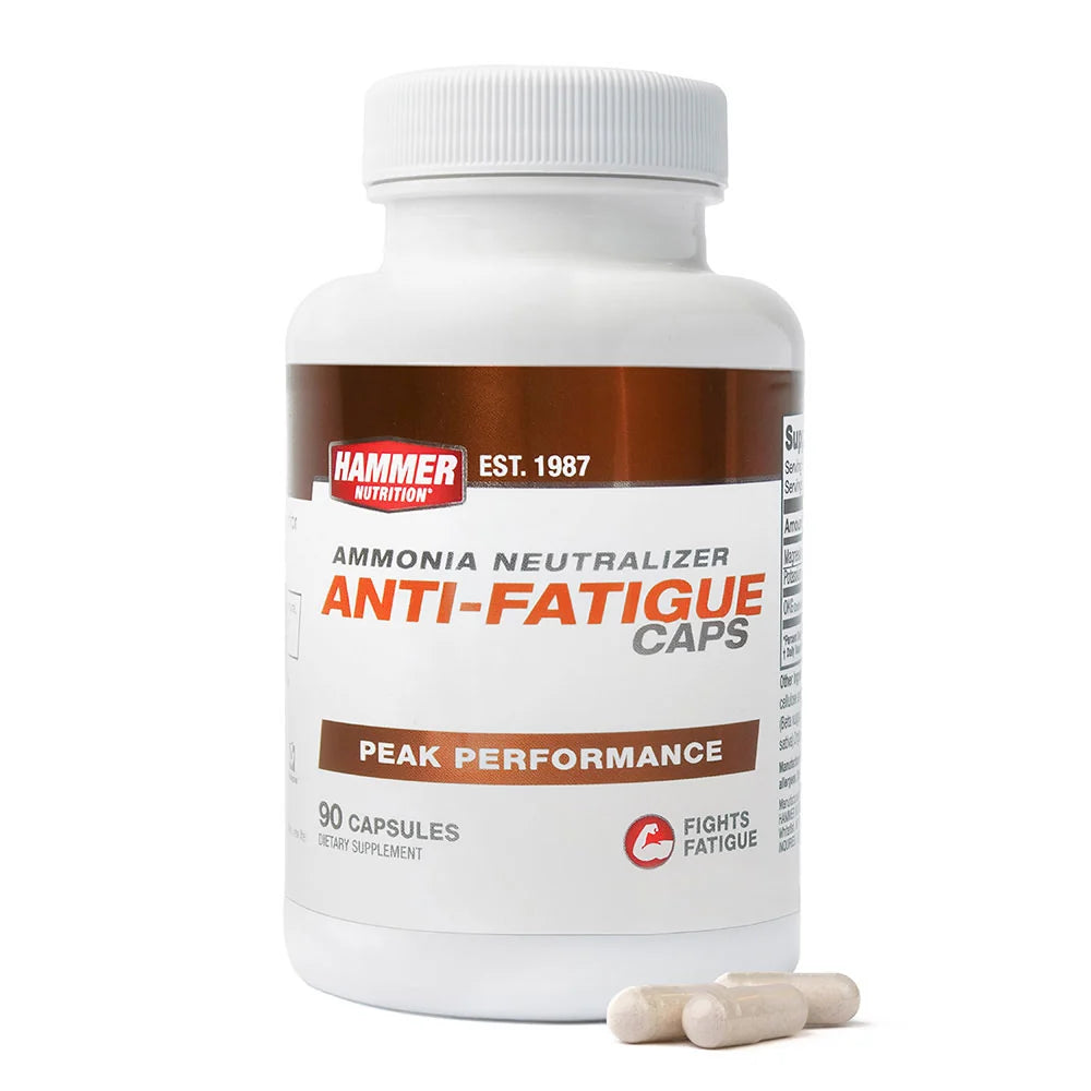 A white bottle of Hammer Nutrition Anti-Fatigue Caps with a brown and white label, shown on a white background with three capsules in front.